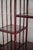 Lacquered arch Bookcase – 1980s Made of red lacquered bamboo with smoked glass shelves and rush bindings. The lower...