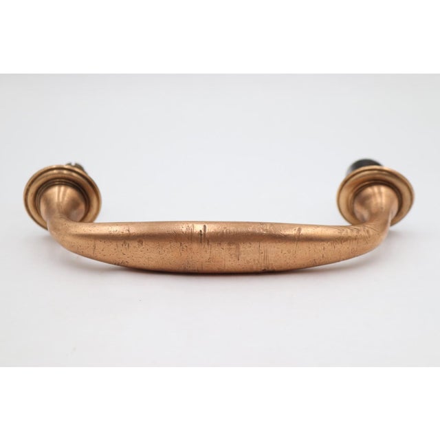Vintage door pull handle made of brass with a polished warm finish. Mounting screws are included. Good condition with...