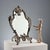 Rococo style bronze table mirror with leaf scroll decorations, plant motifs and shells. This piece is attributed to the...