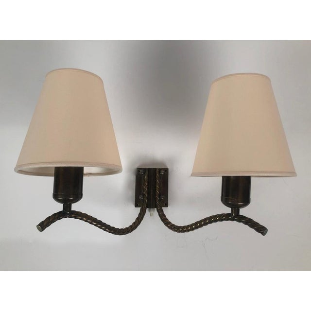 An interesting brass wall lamp from the 1930's. A well thought out lamp with twisted brass arms in appearance contrasted...