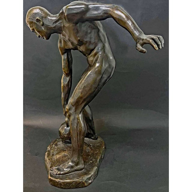 This highly rare bronze of a nude male athlete preparing to left a heavy kettlebell weight was sculpted by an Austrian...