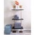Modern multi-tier shelf in aged brass and black shelves, details urban simplicity with burnished finishes. Marais Shelf...