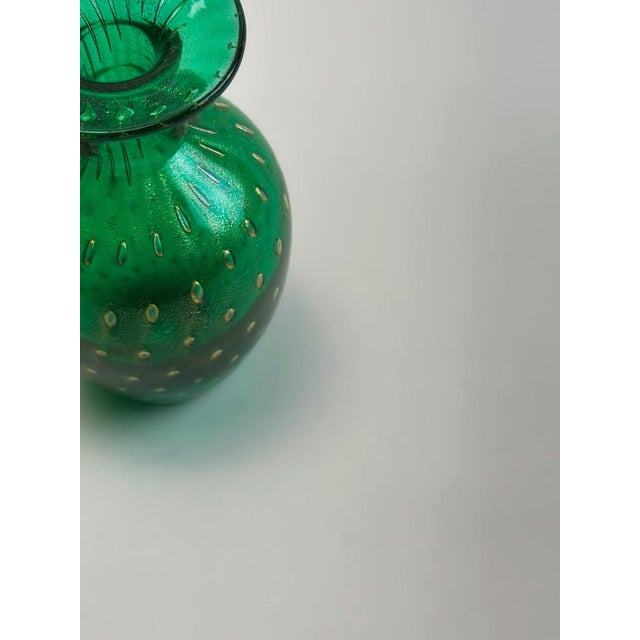 A miniature Murano glass vase in vivid emerald green, attributed to Archimede Seguso and crafted in Italy circa 1980s....