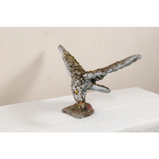 A French bird garden statue in case stone from the mid 20th century. This mid-century statue from France, created in cast-...
