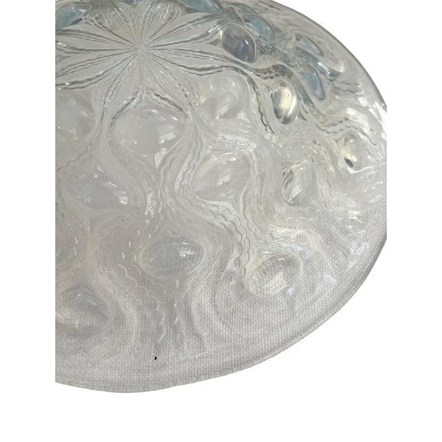 This beautiful decorative plate is a genuine Rene Lalique piece. It has a stunning opalescent sheen and refracts light...