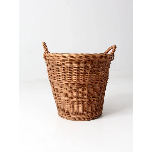 This beautiful wicker basket adds a touch of vintage charm to any room. With its short handles, it can easily be used as a...