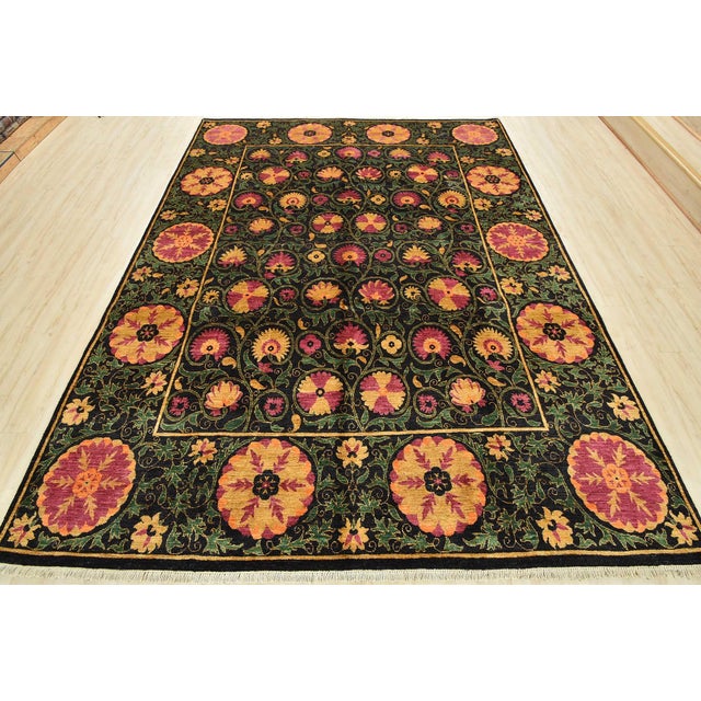This traditional Suzani rug is hand-knotted with an all-wool pile on a cotton foundation. This rug is new and in excellent...