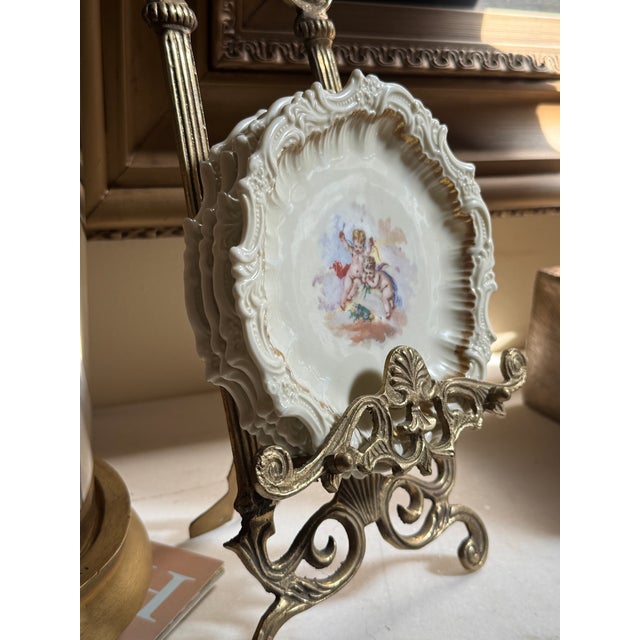 Antique French T&V Limoges porcelain cherub plates, offered as a matched set of four. Each plate features a different...