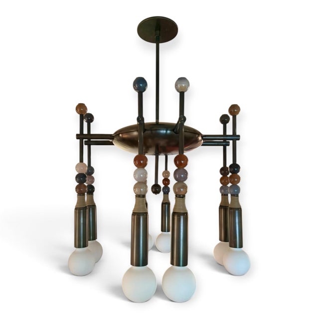 Striking chandelier from covetable Apparatus Studio. From the Talisman line, this custom piece consists of eight finely...