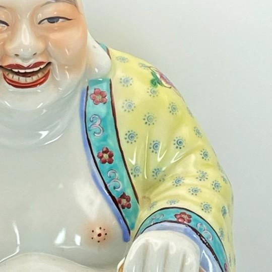 Large and beautifully made Chinese polychrome porcelain “Laughing Buddha” statue, styled in the colorful famille rose...