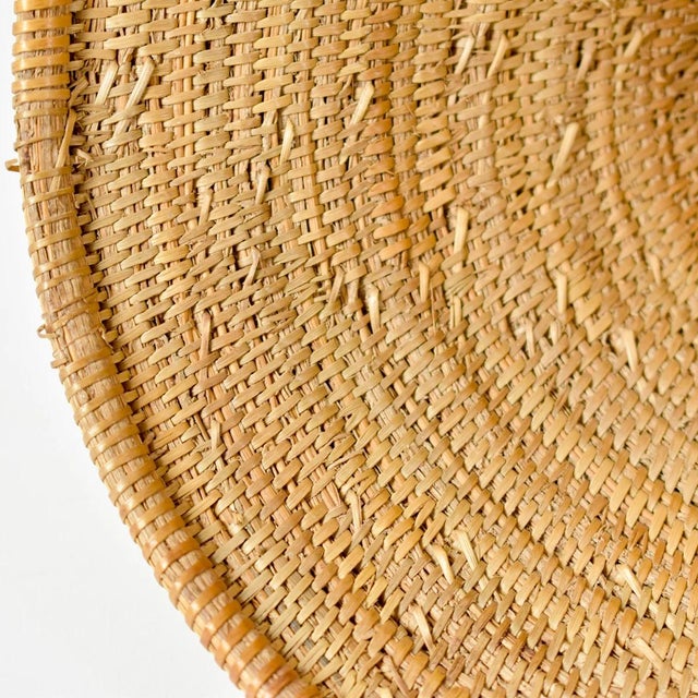 The Tutsi Tight Weave Basket Lid from Rwanda epitomizes the artistry and tradition of the Tutsi community's weaving...