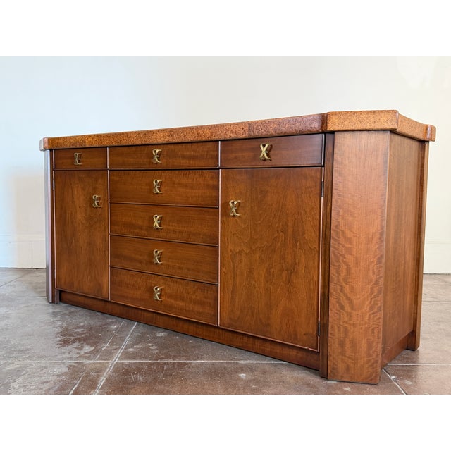 Mid century cork and tobacco finish credenza by Paul Frankl for Johnson Furniture. Signed. Dimensions 72” x 20” d x 32.25”