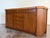 Mid century cork and tobacco finish credenza by Paul Frankl for Johnson Furniture. Signed. Dimensions 72” x 20” d x 32.25”