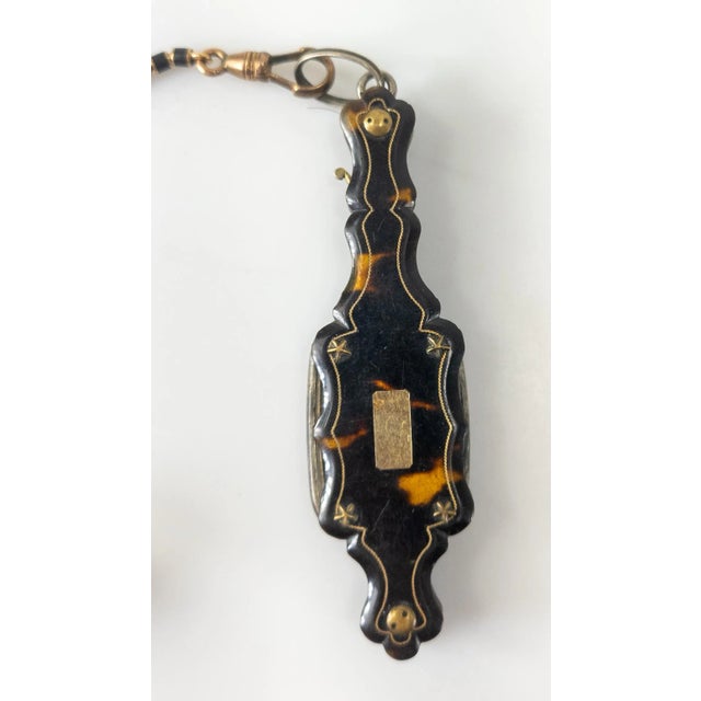 We are selling this beautiful Victorian lorgnette with inlaid gold decoration and gold and enamel watch fob with inset...