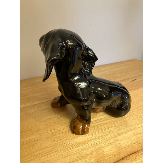 Vintage Goebel Black & Tan DeShun’s figurine measuring 6 1/2”H x 7 3/4” L x 4 3/4” W.