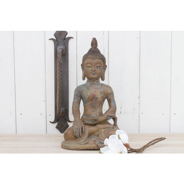 Found in Thailand, this tall antique Buddha was made from bronze. This Thai buddha is show in the "Bhumisparsha Mudra". It...