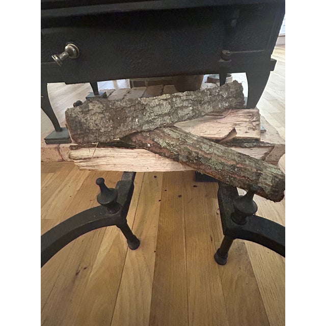 This is an exceptional pair of antique English brass and iron fireplace andirons dating to the late Victorian/early...