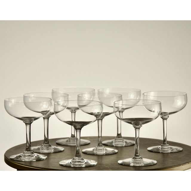 A set of eight French crystal champagne or sherbet coupes by Baccarat, each signed on the underside of the foot with the...