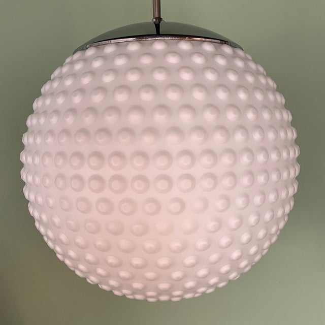Bubbel pendant lamp by German designer Rolf Krüger for Staff-Leuchten, model P117. The lamp is made of opal glass with a...
