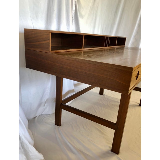 Teak flip-top desk designed by Peter Lovig Nielsen with stamp underneath. Desk has (4) drawers with circular scoop handles...