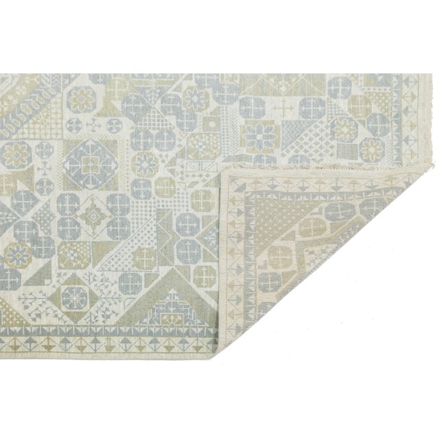 Enhance your space with the elegant Modern Khotan Style Rug, handcrafted from premium wool. This piece reinterprets...