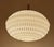 Mid century vintage pendant light with a flattened composite acrylic globe shade with diamond relief patterns and brass...
