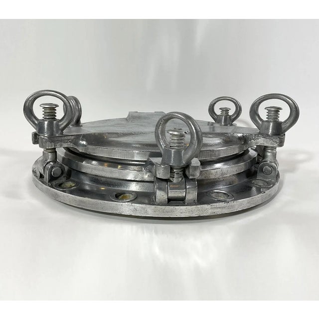 Massive ships porthole built of solid aluminum with glass window and hinged solid aluminum door. Industrial design at its...