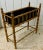 Beautiful faux-bamboo turned planter stand with black painted metal liner .