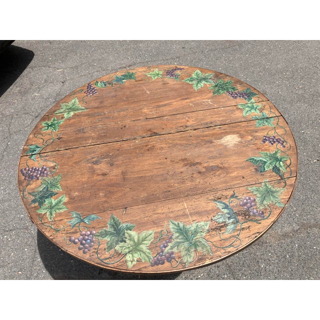 This early 19th century vintners tasting table features a garland of hand painted grapes & leaves on the outside edge This...