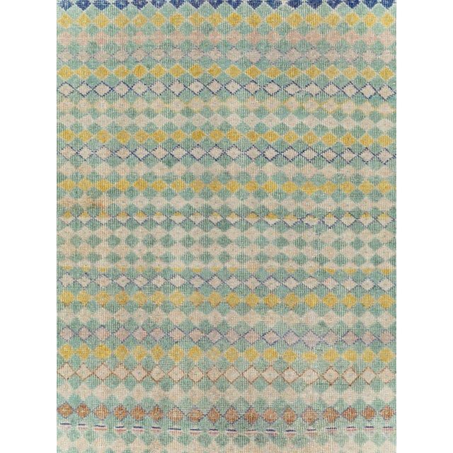 This mid-20th-century Turkish Anatolian gallery carpet presents a finely ordered field of small diamonds arranged in...