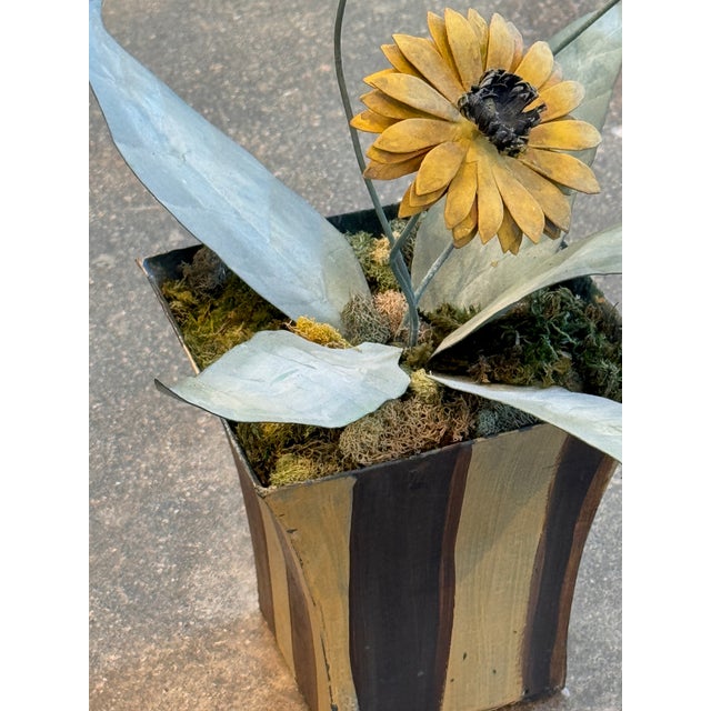 Three tole sunflowers with yellow petals and dark centers on wire stems, with silvered tole leaves, set in a striped...