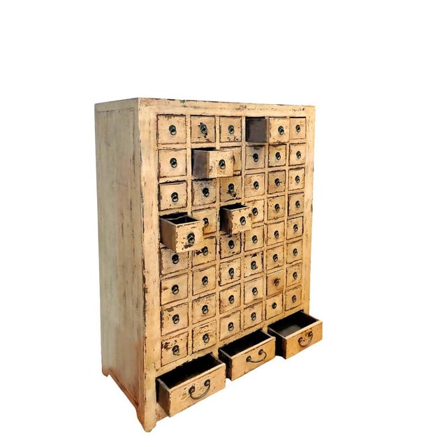 Traditional ancient Chinese pharmacy, in elm, with its original ocher lacquer Each drawer has 4 internal compartments. The...