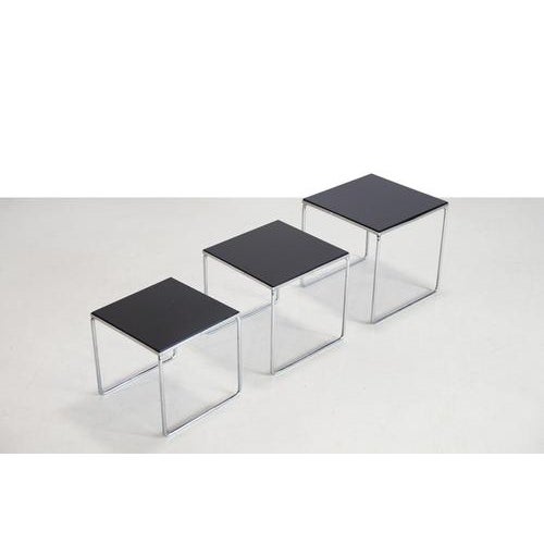 Set of three chrome and black glass side tables. Handy as individual side tables that can be nested together when they...
