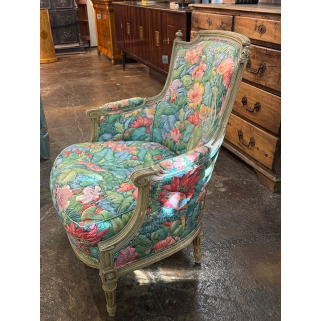 The product is a 19th century Louis XVI painted bergere chair with palm beach fabric. This elegant and refined chair is...