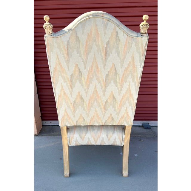 Vintage Regency Arm Chair with Ikat Print in soft neutrals. Wood in light colored with top finials. Carved detail on front...
