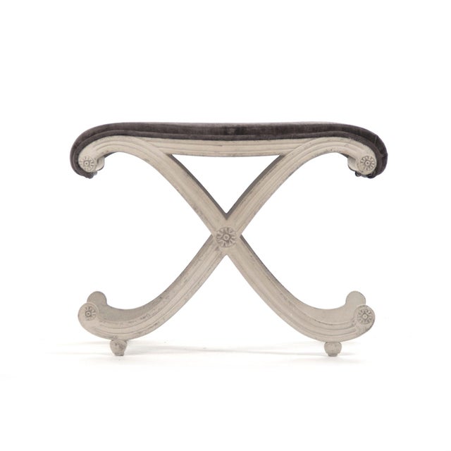 The Coral Stool from Zentique is a petite French vanity stool with a grey velvet padded seat on a distressed off-white...