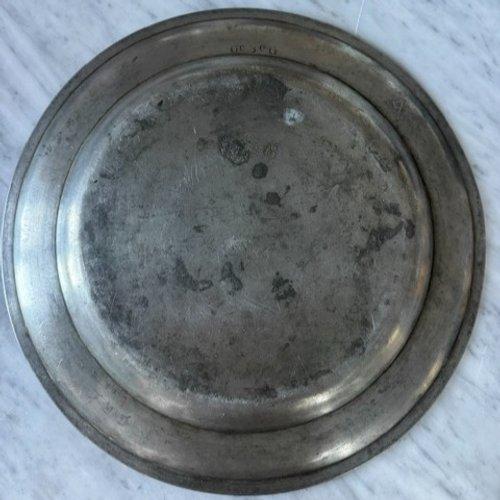 A monumental antique pewter charger or large deep serving platter, notable for its impressive scale, substantial weight,...
