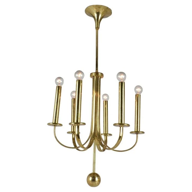 Elegant brass six arm chandelier with minimal contours and original patina. Up to 250V (Europe/UK Standard).The wiring of...