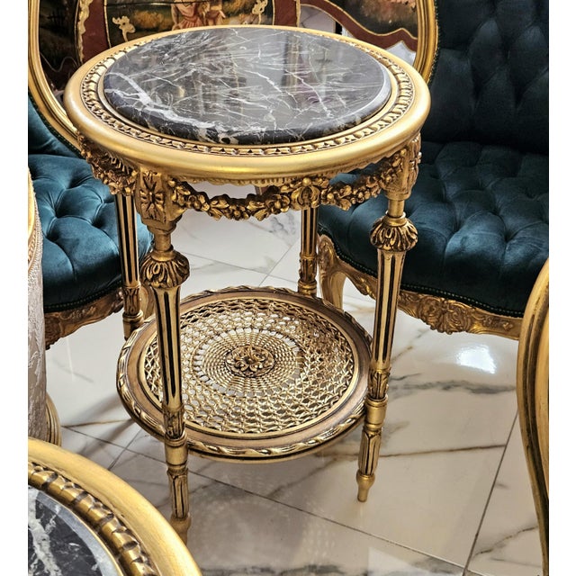Add a touch of timeless sophistication to your interior with this elegant French-inspired side table, featuring an ornate...