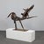 This expressive iron sculpture by Raphael Saintenoy captures the dynamic energy of motion through a raw, almost...