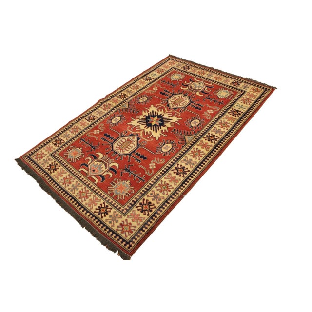 Embellish your home with this exquisitely hand-knotted Super Kazak Rug made with the finest hand spun wool and all...