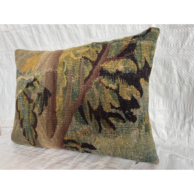 This exceptional 17th century Flemish tapestry pillow is crafted from an authentic fragment of an early verdure tapestry...