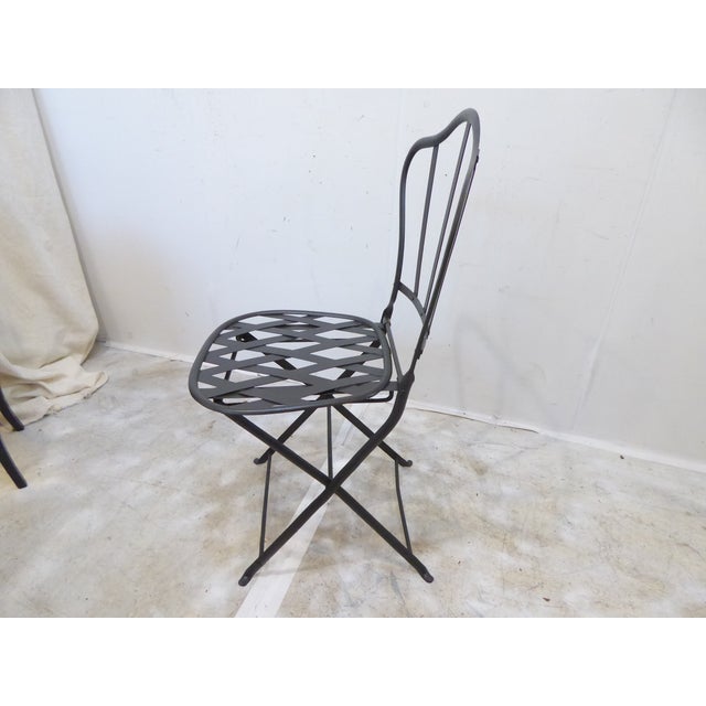 This French iron folding garden chair is painted a gray washed black.