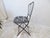 This French iron folding garden chair is painted a gray washed black.