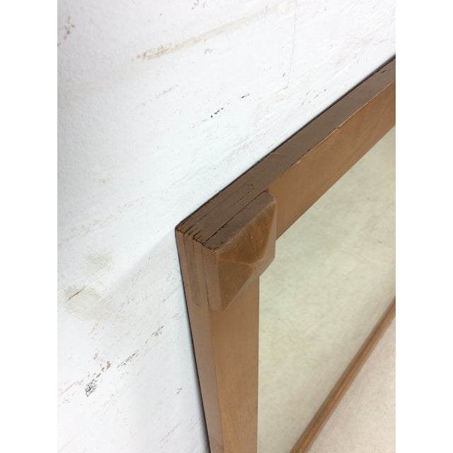 This mid century modern mirror features long hardwood frame, original walnut finish, beveled wood accents on top corners,...