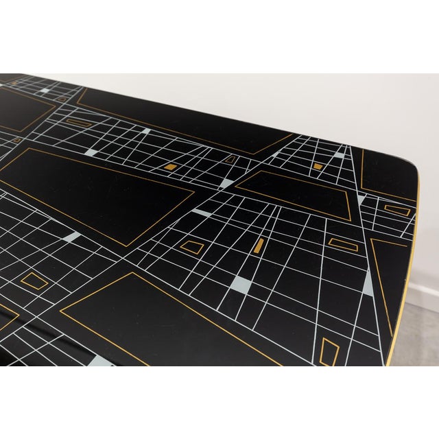 Table rectangular with rounded corners and four legs topped with brass. Glass cover with geometric design. Presents a side...