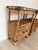 Pair of vintage rattan nightstands featuring custom glass tops, open shelving, and lower cabinet storage with charming...