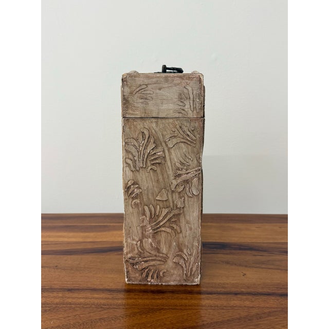 A charming hand-painted wine storage chest featuring a faux bois finish accented with a botanical floral panel and carved...
