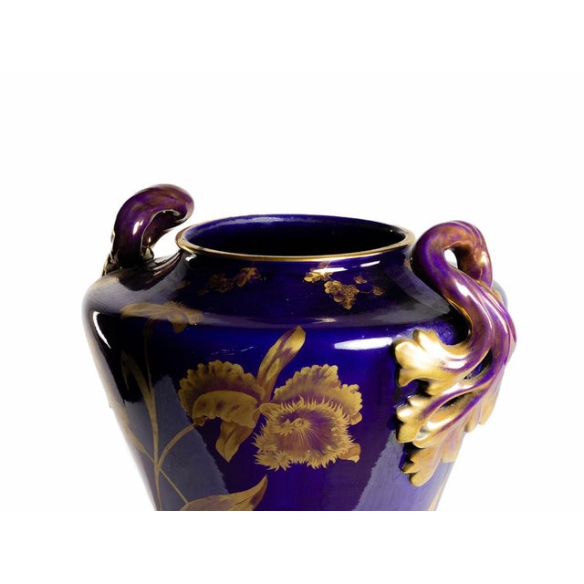 The vase showcases a masterful application of the iconic “bleu de Tours” glaze, a deep cobalt hue emblematic of high-...