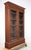 Traditional style double door walnut bookcase cabinet with five adjustable wood shelves enclosed. This features the...